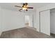 Comfortable bedroom features neutral carpet, ceiling fan, and a closet for storage at 2776 Tusket Ave, North Port, FL 34286