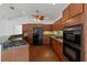 Well-equipped kitchen with cherry cabinets, granite countertops, and stainless steel appliances at 2776 Tusket Ave, North Port, FL 34286