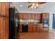 Kitchen featuring wood cabinets, stone backsplash, stainless appliances, and granite countertops at 2776 Tusket Ave, North Port, FL 34286