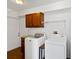 Functional laundry room with washer, dryer, cabinet storage, and convenient countertop at 2776 Tusket Ave, North Port, FL 34286