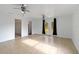 Spacious living room with tile flooring, ceiling fans and french doors to the exterior at 2776 Tusket Ave, North Port, FL 34286