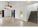 Bright living room with tile floors, stairs, large windows, high ceilings, and ceiling fans at 2776 Tusket Ave, North Port, FL 34286