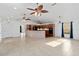 Open floor plan with living space that leads to kitchen with dark appliances and high ceilings at 2776 Tusket Ave, North Port, FL 34286