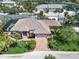 A captivating aerial view reveals this tropical residence, featuring lush landscaping and a brick driveway at 2779 N Beach Rd # A, Englewood, FL 34223