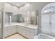 Elegant bathroom with marble countertops, dual sinks and soaking tub under a window at 2779 N Beach Rd # A, Englewood, FL 34223