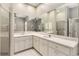 Large, bright bathroom featuring dual sinks, walk-in shower, and tub under a window at 2779 N Beach Rd # A, Englewood, FL 34223