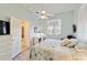 Comfortable bedroom with ensuite bathroom, ceiling fan, and plenty of sunlight at 2779 N Beach Rd # A, Englewood, FL 34223