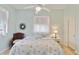 Cozy bedroom features a ceiling fan, wood floors, and a sunny window at 2779 N Beach Rd # A, Englewood, FL 34223