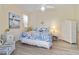 Charming bedroom with coastal decor, ceiling fan, and light wood floors at 2779 N Beach Rd # A, Englewood, FL 34223
