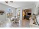 Dining area with light wood floors and a round white table is adjacent to the living room at 2779 N Beach Rd # A, Englewood, FL 34223