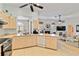 Bright kitchen with appliances, tile floor and view to living room with fireplace at 2779 N Beach Rd # A, Englewood, FL 34223