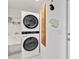 Efficient laundry area with stacked washer and dryer, sink, and decorative touches at 2779 N Beach Rd # A, Englewood, FL 34223