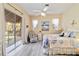 Inviting bedroom with lanai access, ceiling fan, and serene decor at 2779 N Beach Rd # A, Englewood, FL 34223