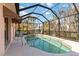 Screened in pool offering a private backyard oasis and tranquil escape surrounded by tropical landscaping at 2779 N Beach Rd # A, Englewood, FL 34223