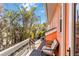 Outdoor porch with a white cushioned chair and nearby lush landscaping at 2779 N Beach Rd # A, Englewood, FL 34223