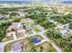Overview of a single-Gathering home neighborhood surrounded by lush greenery and trees at 3140 Lopinto St # 1, North Port, FL 34287