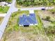New single Gathering home with a dark roof, and green grass and palm tree landscaping at 3140 Lopinto St # 1, North Port, FL 34287