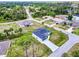 A modern single-Gathering home with a long driveway, lush greenery, and a well-maintained lawn at 3140 Lopinto St # 1, North Port, FL 34287