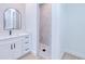 Stylish bathroom featuring a modern vanity with black hardware, arched mirror, and a marble-tiled walk-in shower at 3140 Lopinto St # 1, North Port, FL 34287
