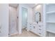 Modern bathroom featuring a walk-in shower, a white vanity with marble counters, and built-in shelving at 3140 Lopinto St # 1, North Port, FL 34287