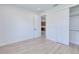 Bright bedroom with wood-look flooring, a closet, and an open doorway leading to other rooms at 3140 Lopinto St # 1, North Port, FL 34287