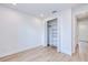 Bright bedroom features a large closet with shelving, light wood floors, and white trim at 3140 Lopinto St # 1, North Port, FL 34287
