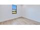 Bright bedroom features wood-look flooring, a modern window, and clean, minimal trim for a contemporary look at 3140 Lopinto St # 1, North Port, FL 34287