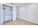 Bedroom featuring wood-look floors, a closet with bi-fold doors, and bright, neutral walls at 3140 Lopinto St # 1, North Port, FL 34287