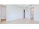 Bright bedroom featuring white walls, light wood-look flooring, and access to a closet and bathroom at 3140 Lopinto St # 1, North Port, FL 34287