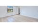 Light-filled bedroom with wood-look flooring and a window offering natural light at 3140 Lopinto St # 1, North Port, FL 34287