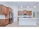 Beautiful kitchen with wood cabinets, stainless steel appliances, and a quartz island at 3140 Lopinto St # 1, North Port, FL 34287