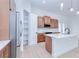 Bright kitchen featuring wood cabinets, stainless steel appliances, and a center island with a white countertop at 3140 Lopinto St # 1, North Port, FL 34287