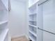 Spacious walk-in closet with custom built-in shelving and hanging rods for optimal organization and storage at 3140 Lopinto St # 1, North Port, FL 34287