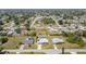 Wide aerial shot showcasing property's location within a quiet residential neighborhood with nearby houses and community amenities at 3187 Elkcam Blvd, Port Charlotte, FL 33952