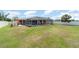 A large, screened-in pool area with an adjacent grassy yard creates a relaxing backyard oasis at 3187 Elkcam Blvd, Port Charlotte, FL 33952