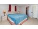 Cozy bedroom with a queen bed, neutral walls, and an ensuite bathroom with tile floors at 3187 Elkcam Blvd, Port Charlotte, FL 33952