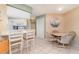 Open-concept kitchen and dining area with breakfast bar, creating a seamless space for cooking and casual dining at 3187 Elkcam Blvd, Port Charlotte, FL 33952