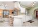 Bright kitchen featuring sleek countertops, crisp white cabinets, and an adjacent dining area with lots of light at 3187 Elkcam Blvd, Port Charlotte, FL 33952