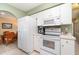 Well-equipped kitchen featuring modern appliances, ample counter space, and a convenient layout for meal preparation at 3187 Elkcam Blvd, Port Charlotte, FL 33952