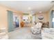 Open floor plan with a living area flowing into the kitchen and dining space, featuring tile flooring at 3187 Elkcam Blvd, Port Charlotte, FL 33952