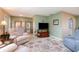Inviting living area featuring plush seating, stylish decor, and ample natural light, creating a warm ambiance at 3187 Elkcam Blvd, Port Charlotte, FL 33952