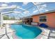 Inviting pool area surrounded by a screened enclosure, providing privacy and a relaxing outdoor space at 3187 Elkcam Blvd, Port Charlotte, FL 33952