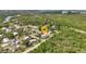 Aerial view pinpointing property's location in neighborhood with close proximity to water and lush greenery at 3215 Cedarbrook Dr, Punta Gorda, FL 33982
