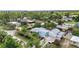 Aerial view showcasing home with a metal roof, spacious driveway, and a well-maintained yard at 3215 Cedarbrook Dr, Punta Gorda, FL 33982