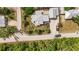 Aerial view of coastal home with a neutral roof, tropical landscape, and crushed shell driveway at 3215 Cedarbrook Dr, Punta Gorda, FL 33982