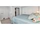 Comfortable bedroom featuring large bed, plentiful white cabinets, and ensuite bathroom at 3215 Cedarbrook Dr, Punta Gorda, FL 33982