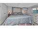 Comfortable bedroom featuring large bed, white cabinets, and cool air conditioning at 3215 Cedarbrook Dr, Punta Gorda, FL 33982
