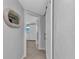 Hallway leading to bedroom with white barn door and decorative mirror at 3215 Cedarbrook Dr, Punta Gorda, FL 33982