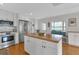 Bright kitchen with white cabinets, stainless steel appliances, and a wooden island countertop at 3215 Cedarbrook Dr, Punta Gorda, FL 33982