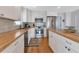 Well-equipped kitchen with stainless steel appliances, white cabinetry, butcher block countertops at 3215 Cedarbrook Dr, Punta Gorda, FL 33982
